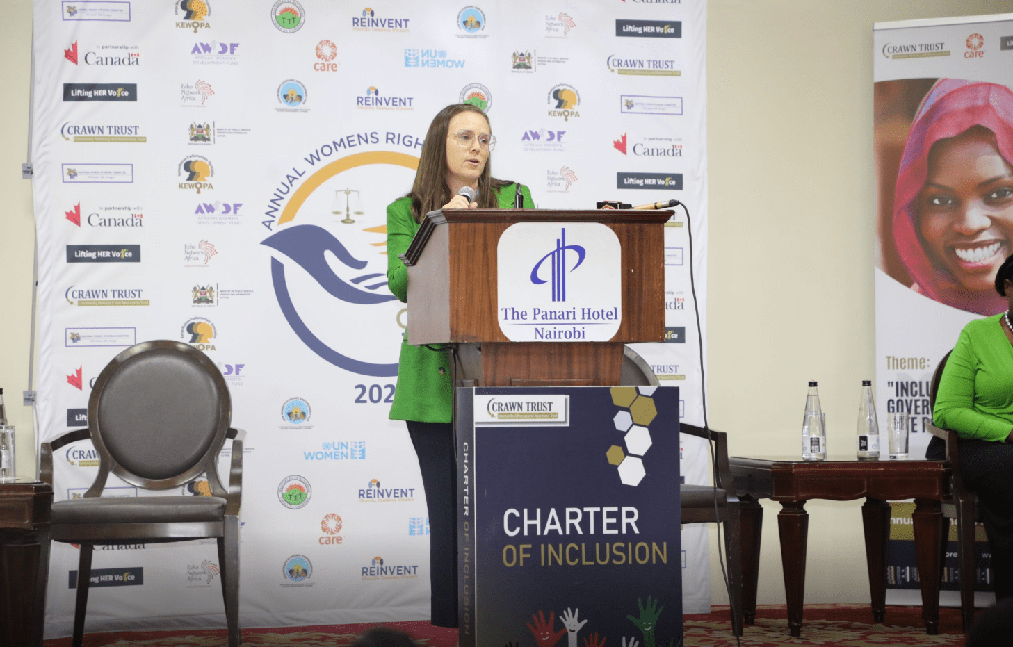 Woman in a green jacket speaking at The Panari Hotel podium